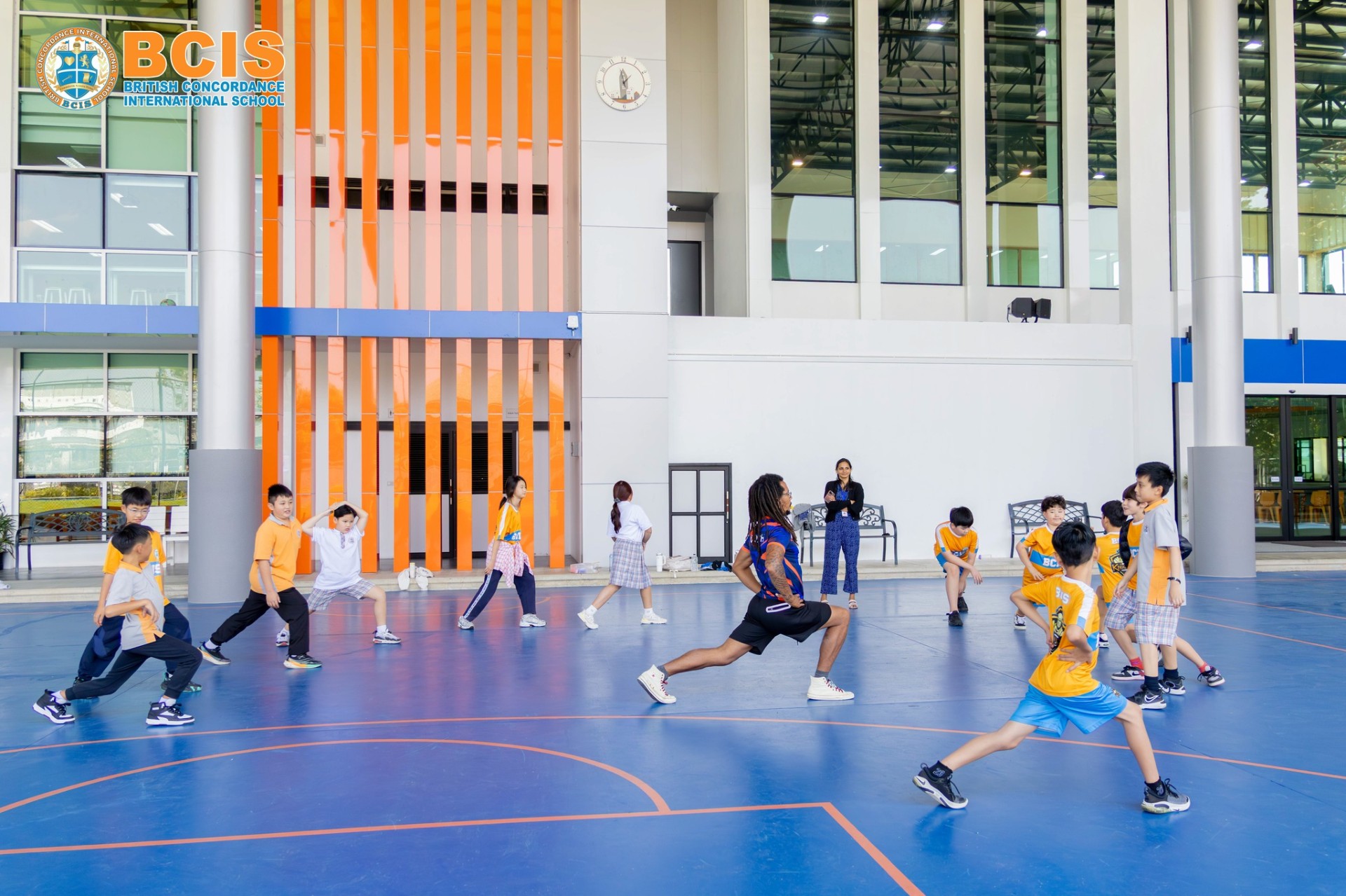 BCIS indoor sports hall with basketball court and badminton nets